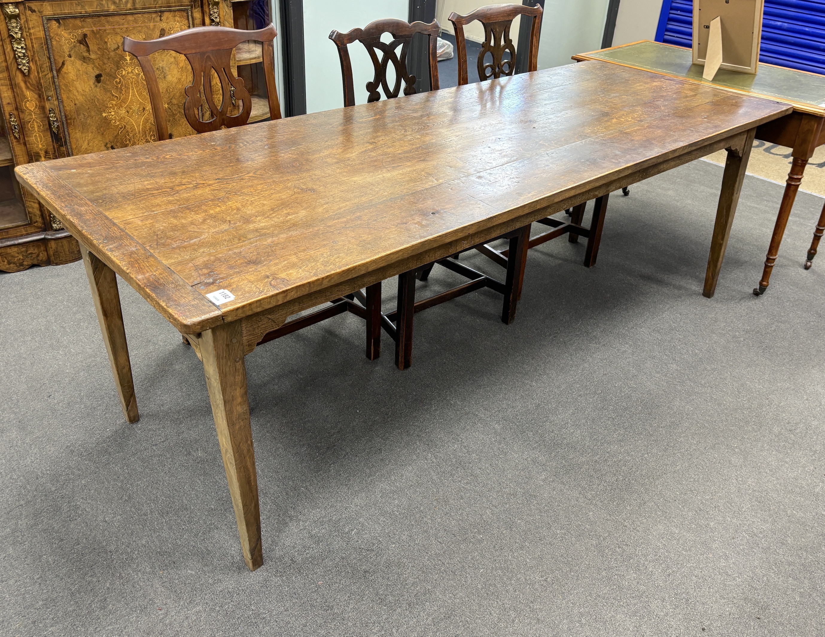 A 19th century rectangular Provincial oak kitchen table with cleated plank top, fitted two drawers on square tapered legs, width 220cm, depth 84cm, height 74cm